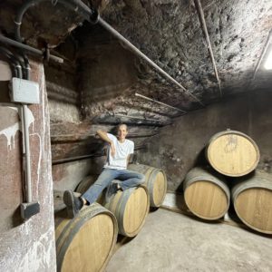 woman sitting on wine barrels